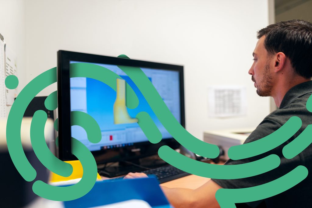 Engineer reviewing a 3D product model on a computer screen